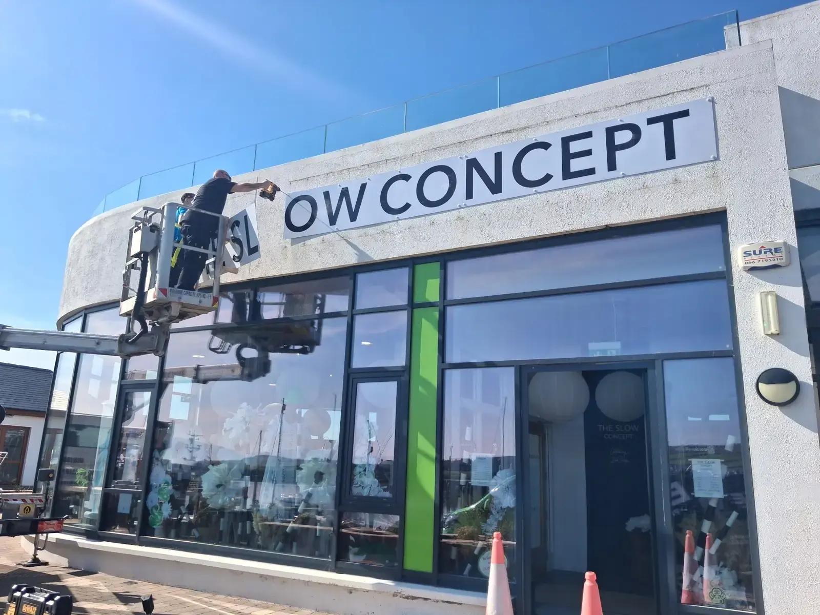 Shopfront signage being installed from a cherry picker